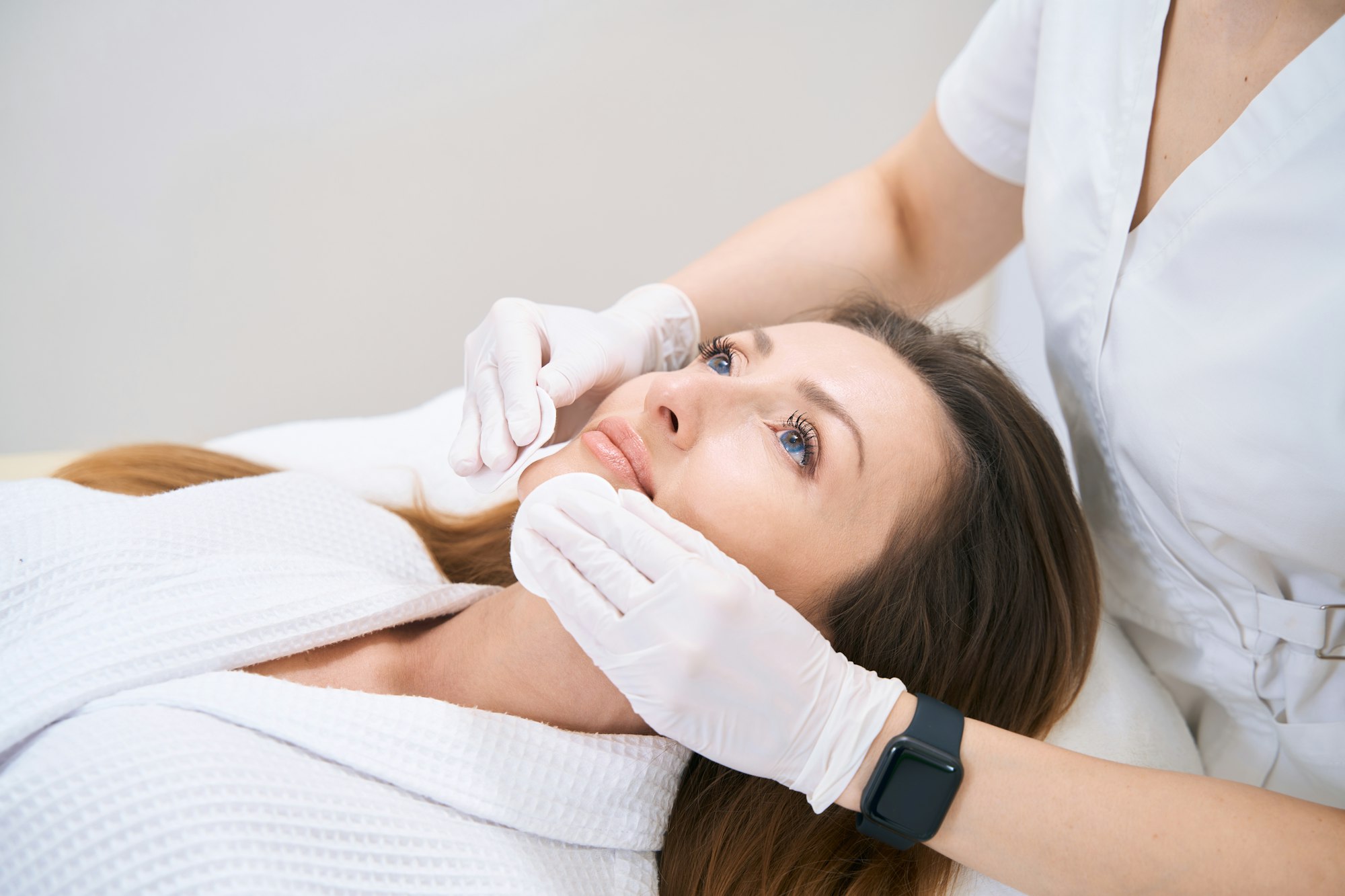 Facial cleansing with cotton swabs in clinic